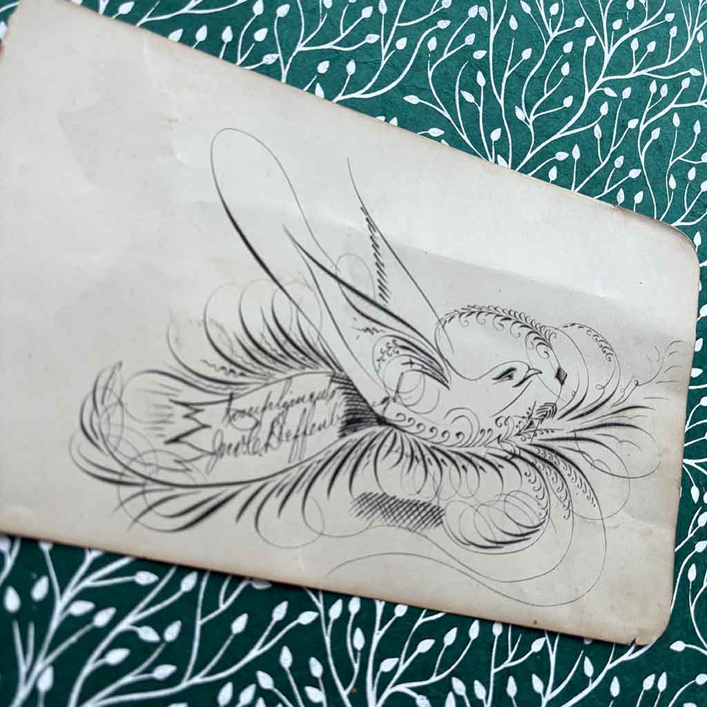 an ornate 1800s signature in the shape of a bird