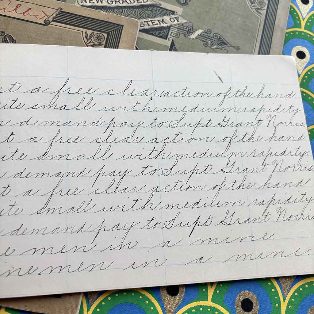 a close up of an 1800s penmanship copy book