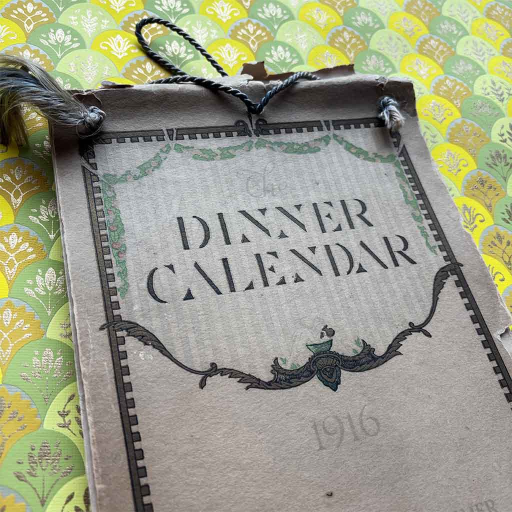 a 1916 Fannie Farmer Dinner Calendar against a brightly colored scalloped background
