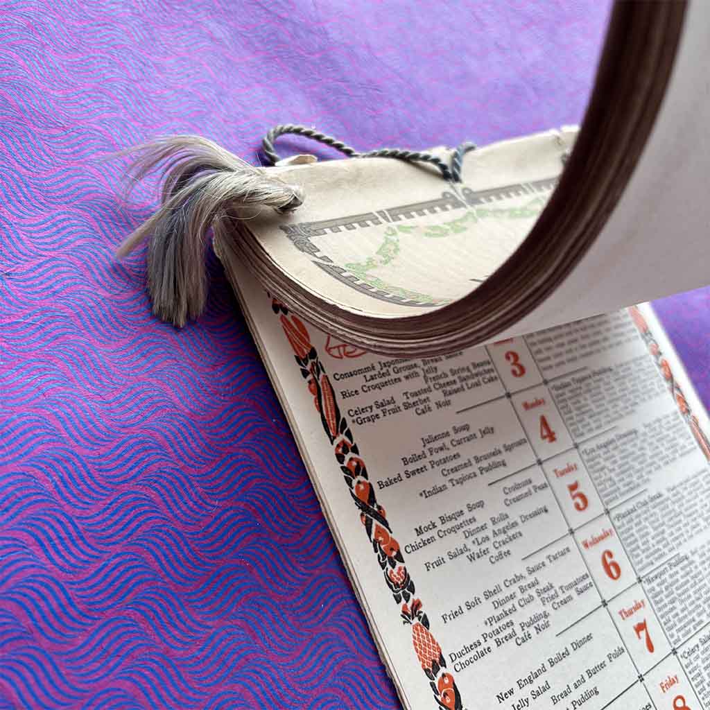 a 1916 Fannie Farmer Dinner Calendar against a brightly colored scalloped background