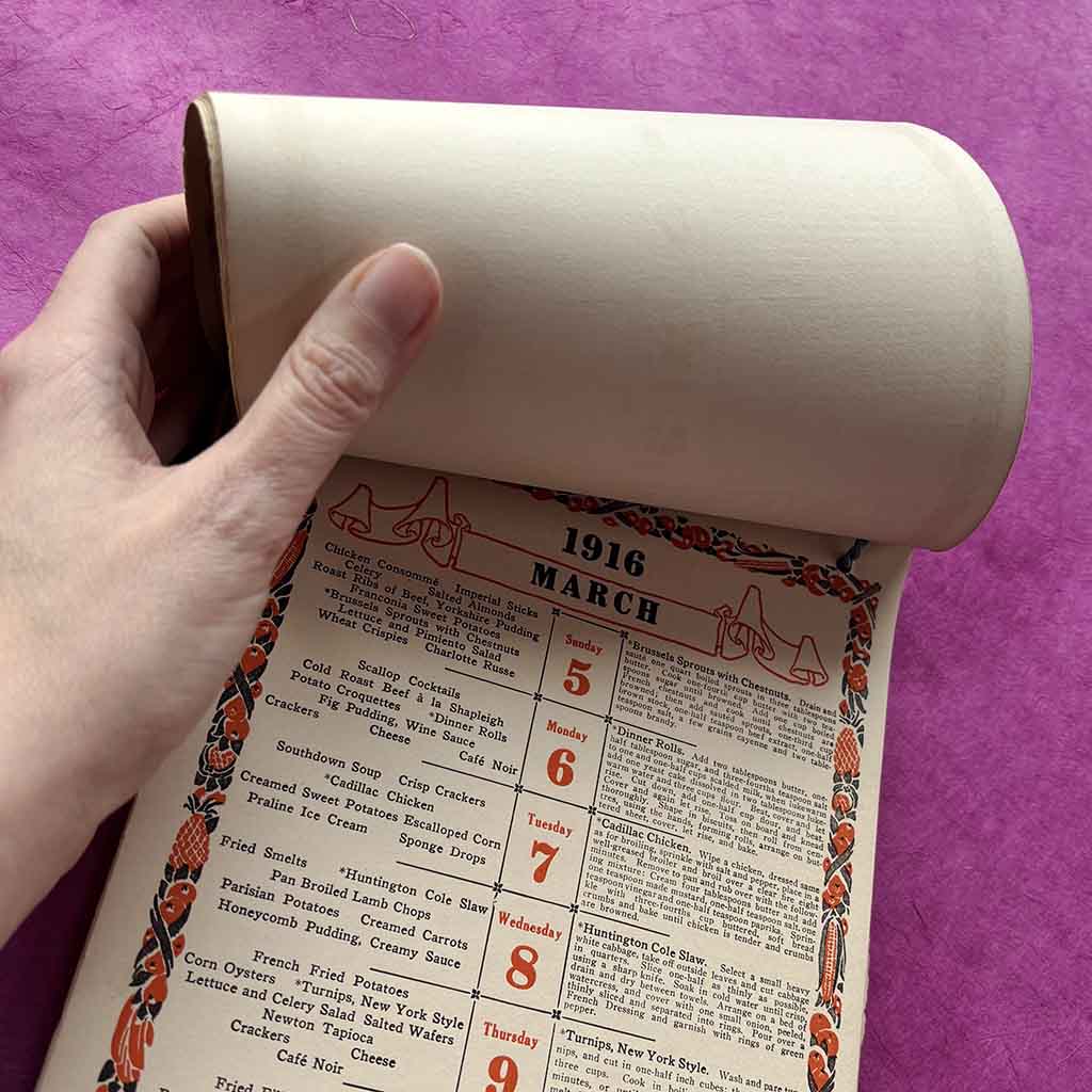 a 1916 Fannie Farmer Dinner Calendar against a pink background