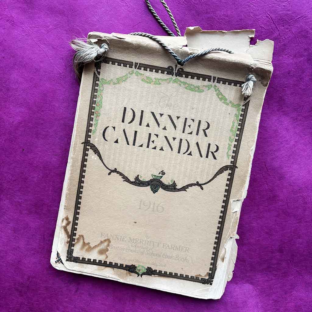 a 1916 Fannie Farmer Dinner Calendar against a pink background