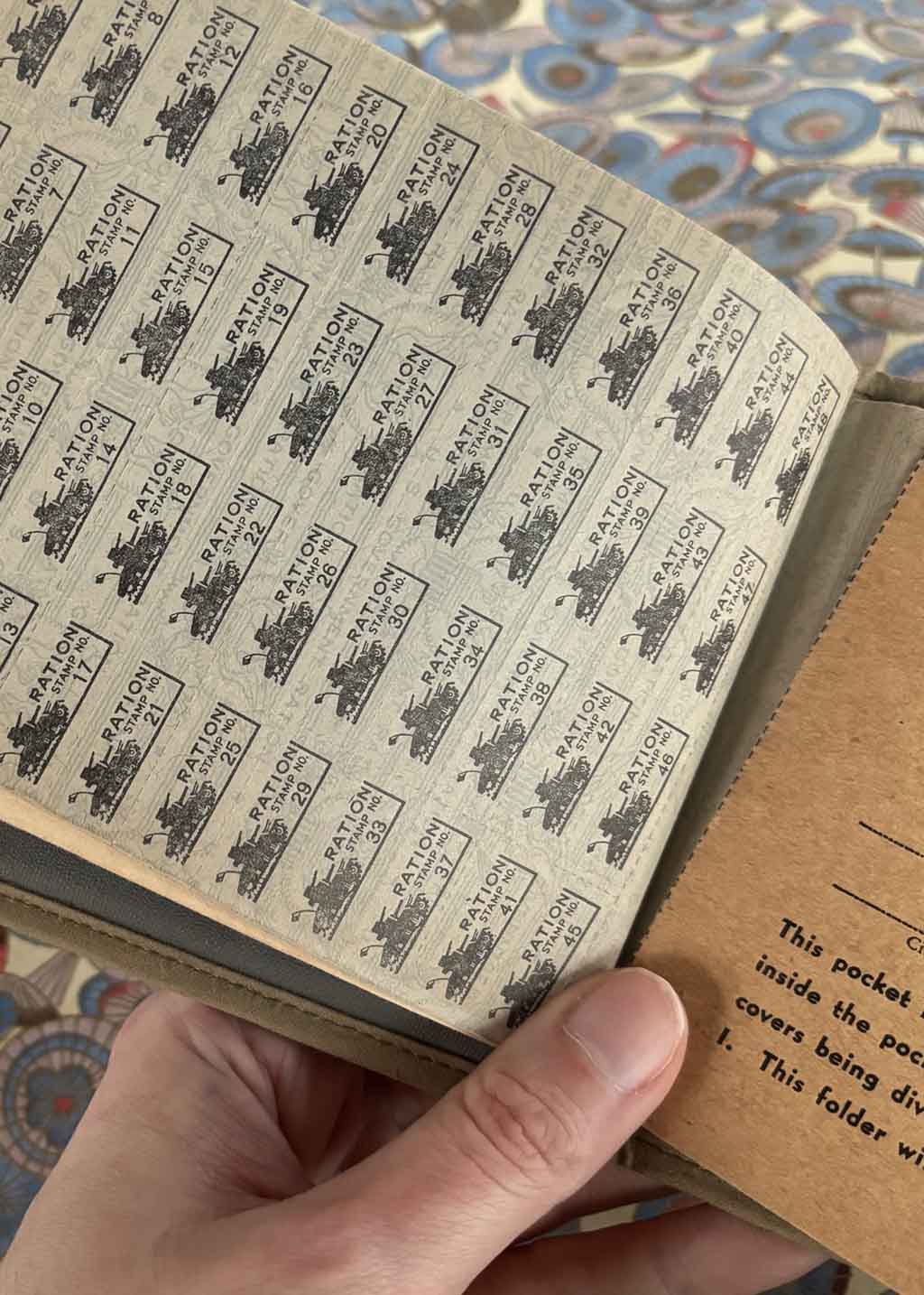 a hand holds some WWII ration books