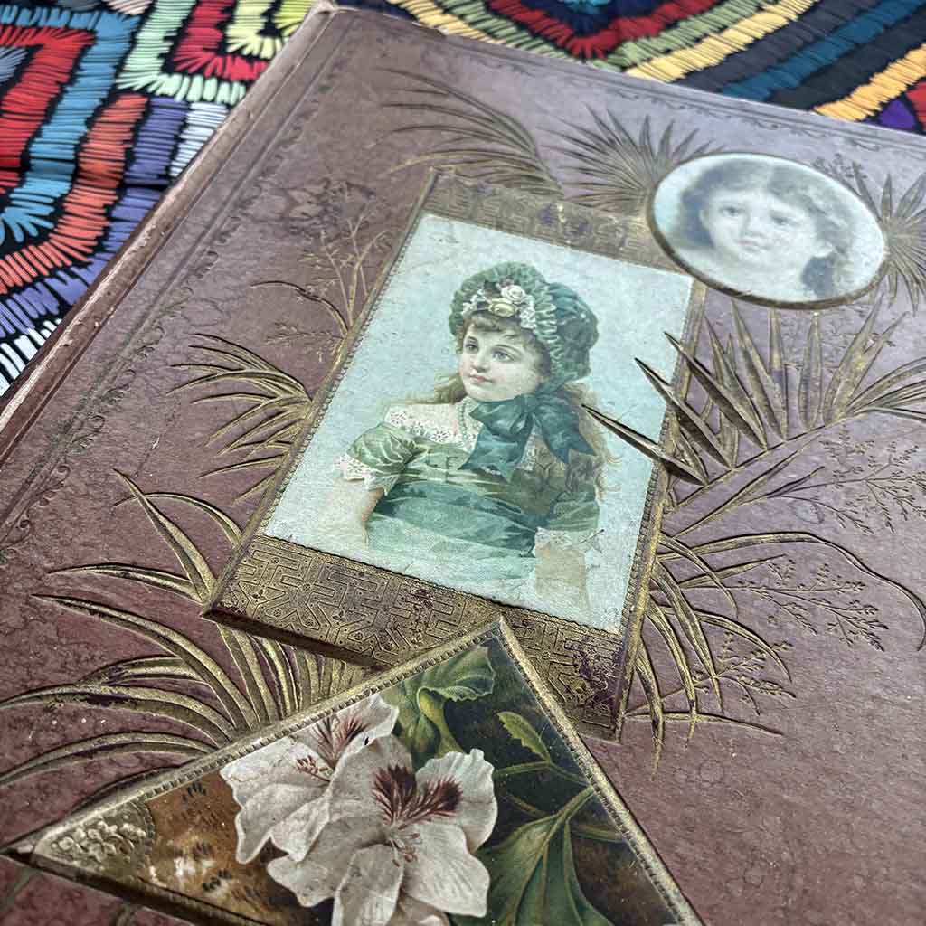 A Victorian Scrapbook against a brightly colored tablecloth