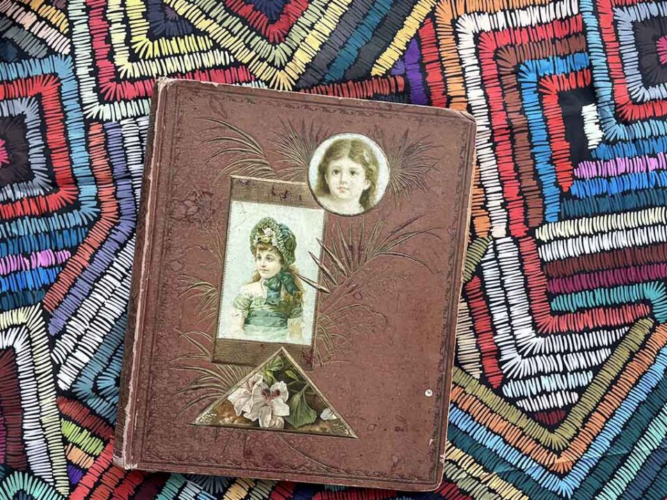 A Victorian Scrapbook against a brightly colored tablecloth