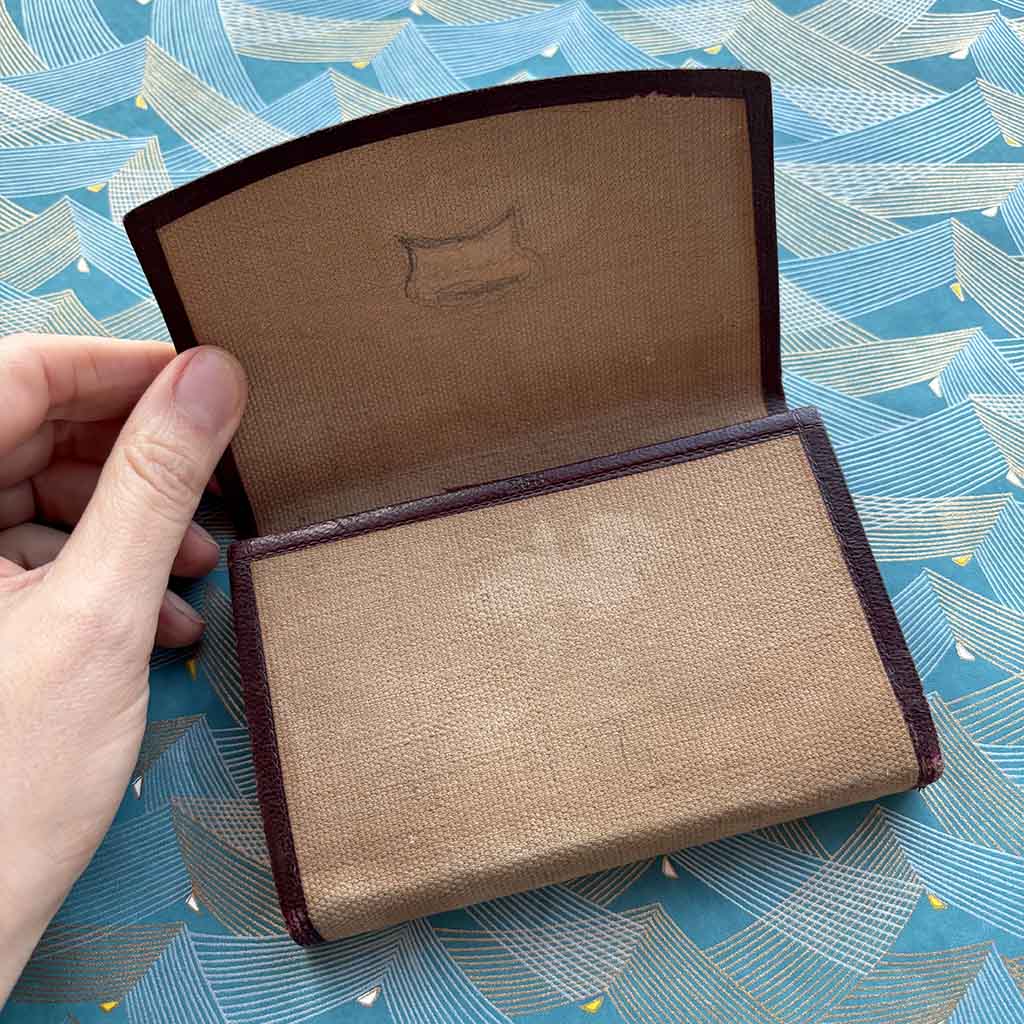 a hand holds open a 1890 Standard Diary